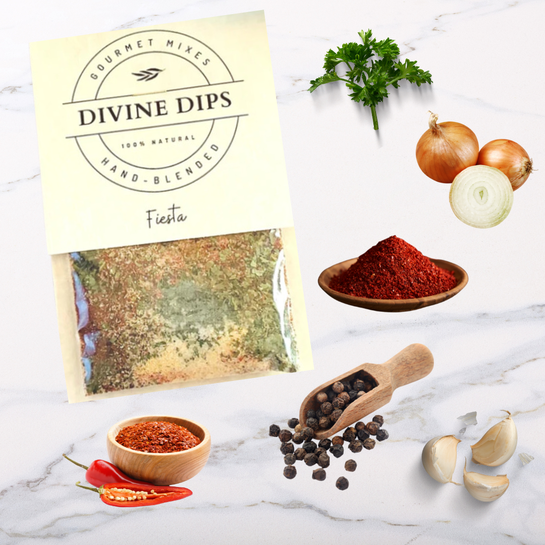 Fiesta Seasoning dip mix in package with raw ingredients surrounding, parsley, onion, chili powder, pepper, garlic, cayenne