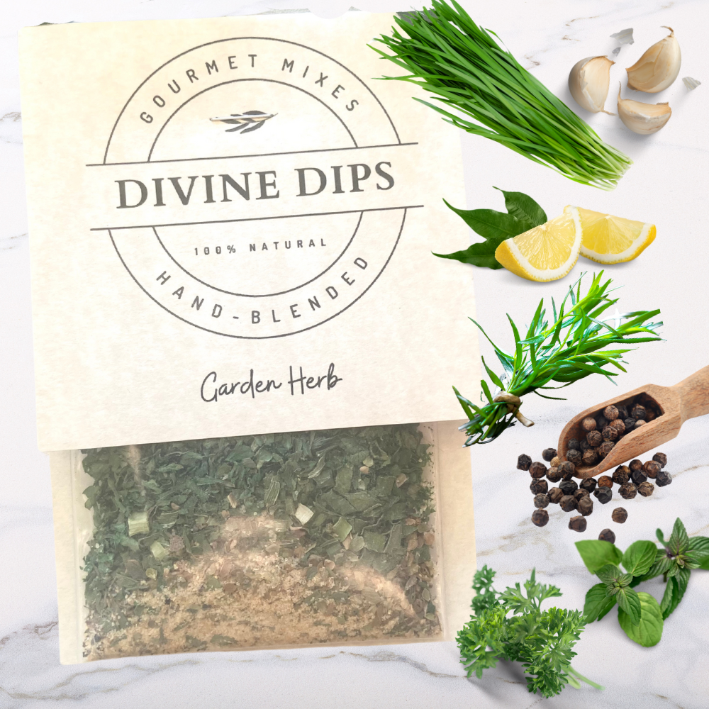 Garden Herb Seasoning dip mix in package with raw ingredients surrounding, garlic, chives, lemon, pepper, tarragon, parsley, basil