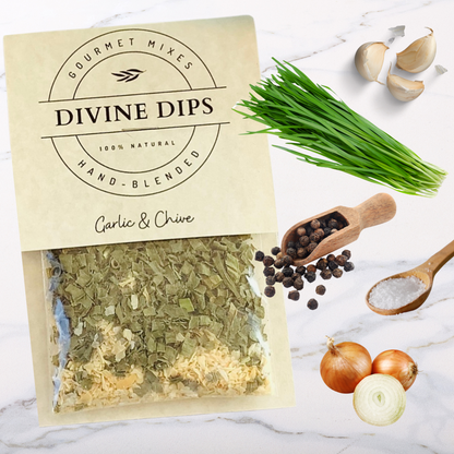 Garlic & Chive seasoning dip mix in package with raw ingredients surrounding, garlic, chives, pepper, salt, onion