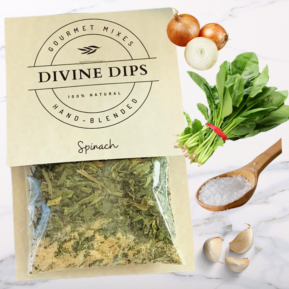Spinach seasoning dip mix in package with raw ingredients surrounding; onion, spinach, salt, garlic, sugar