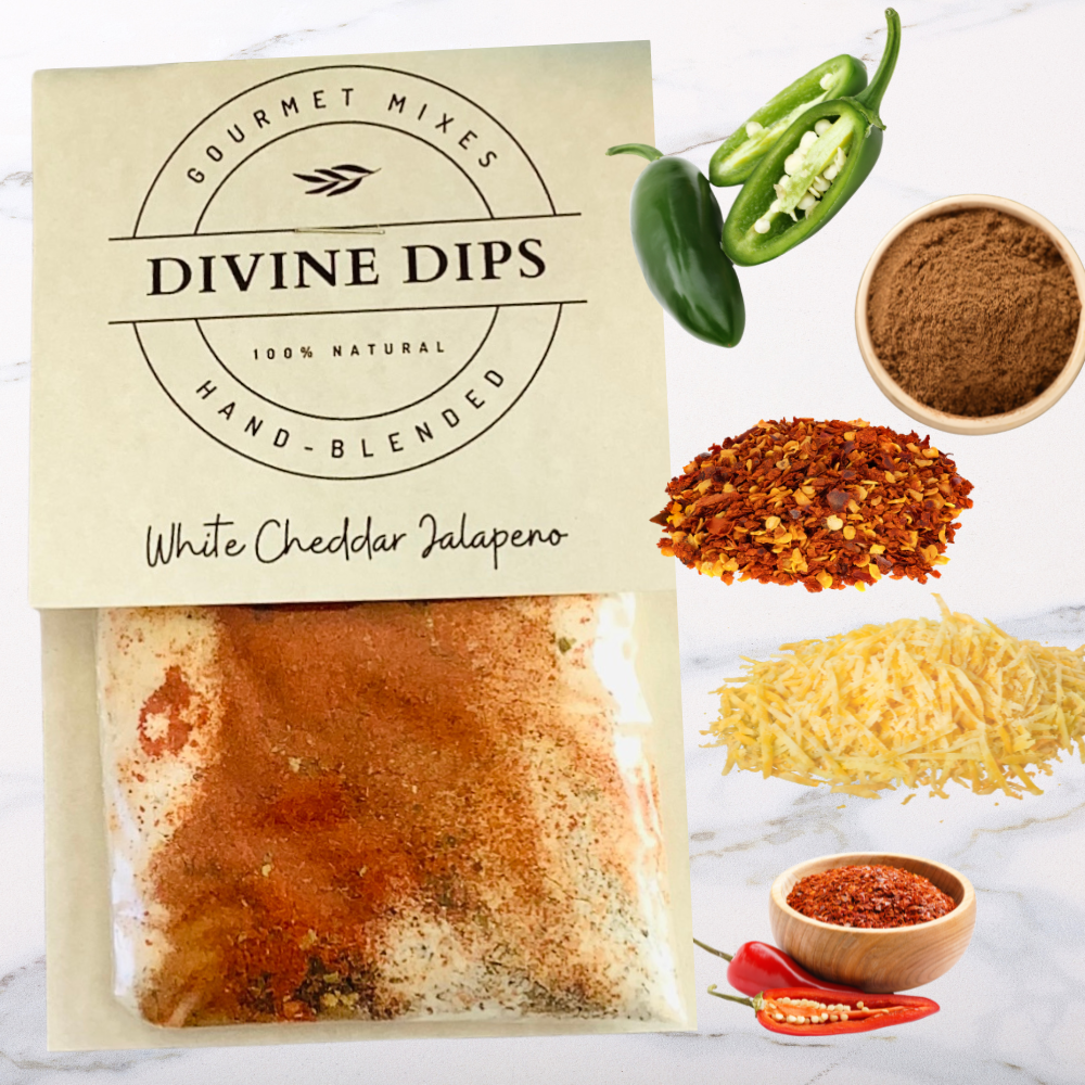 White CHeddar Jalapeno seasoning dip mix in package with raw ingredients surrounding; jalapeno, cheddar, cumin, pepper, cayenne